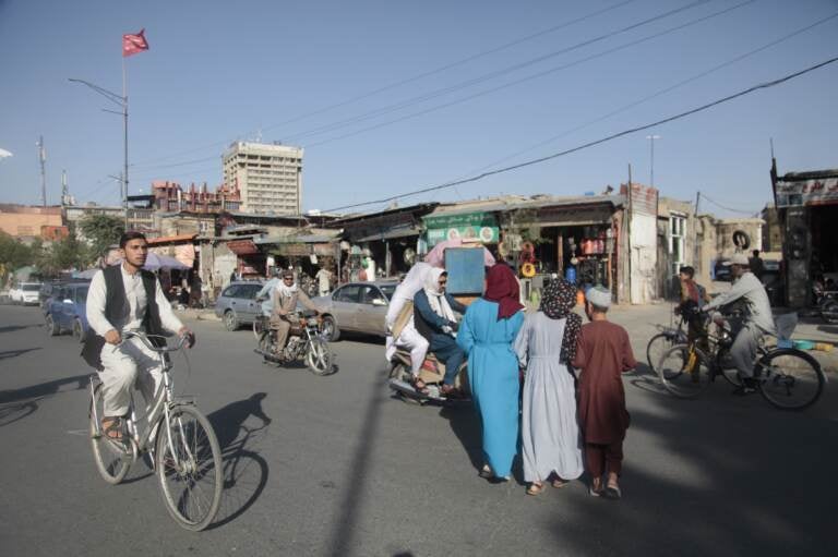 Kabul is seen with men and boys on rickety bicycles