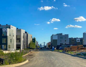 New houses and construction is visible with the Ben Franklin Bridge visible on the horizon.