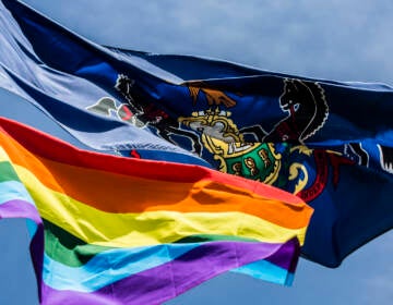 The LGBTQ flag flying alongside Pennsylvania's.