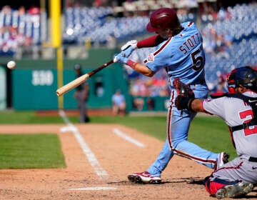 Philadelphia Phillies' Bryson Stott, left, hits a three RBI-double off Washington Nationals' Victor Arano