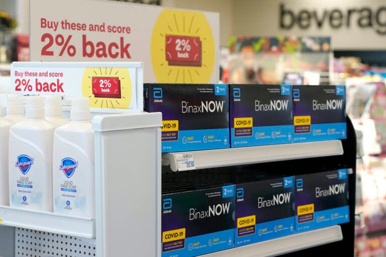 FILE - Boxes of BinaxNow home COVID-19 tests made by Abbott displayed for sale next to liquid hand soap at a CVS store in Lakewood, Wash., Monday, Nov. 15, 2021. People screening themselves at home for COVID-19 may need to use three rapid tests to accurately detect the virus, according to new U.S. recommendations released Thursday, Aug. 11, 2022, that call for a longer testing period. (AP Photo/Ted S. Warren, File)