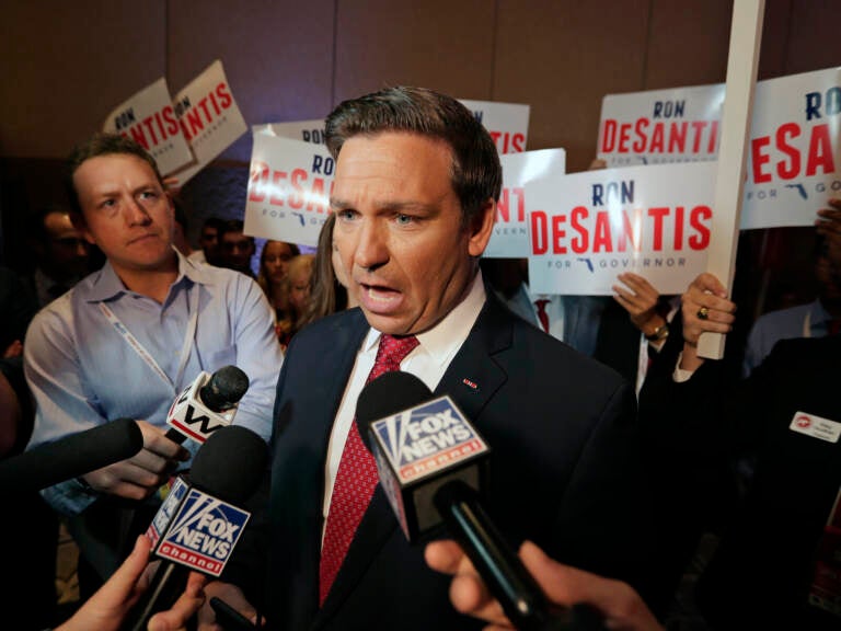 Ron DeSantis speaks with reporters.