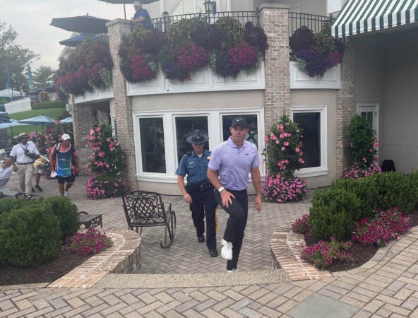Rory McIlroy walks through the courtyard leading to the locker room