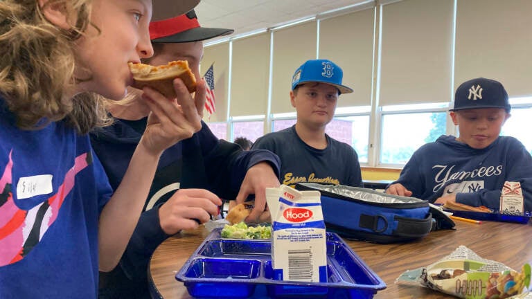 Students eat lunch inside a school