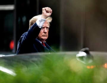 Former President Donald Trump gestures as he departs Trump Tower