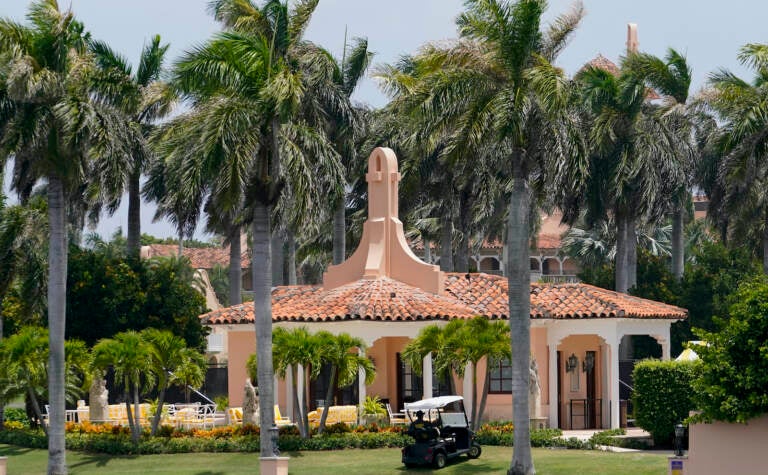 Security moves in a golf cart at former President Donald Trump's Mar-a-Lago estate