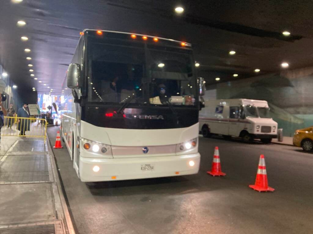 A front of a bus is visible pulling into a tunnel or staiton.