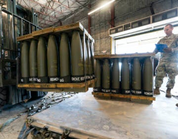 FILE - U.S. Air Force Staff Sgt. Cody Brown, right, with the 436th Aerial Port Squadron, checks pallets of 155 mm shells ultimately bound for Ukraine, April 29, 2022, at Dover Air Force Base, Del. U.S. officials say that as Russia’s war on Ukraine drags on, U.S. security assistance is shifting to a longer-term campaign that will likely keep more American military troops in Europe into the future. They say a new aid package to be announced includes an additional roughly $3 billion to train and equip Ukrainian forces to fight for years to come.  (AP Photo/Alex Brandon, File)