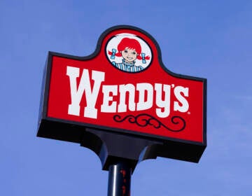 A sign reads Wendys, with a blue sky visible in the background.