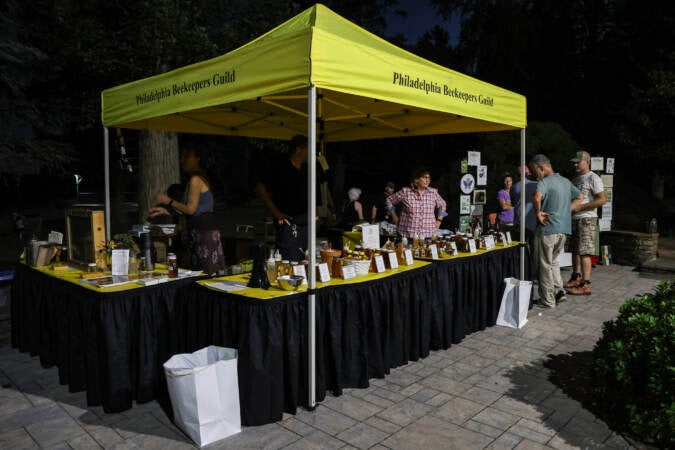 Members of the Philadelphia Beekeepers Guild offer honey samples and products at the Philadelphia Honey Festival. (Kimberly Paynter/WHYY)
