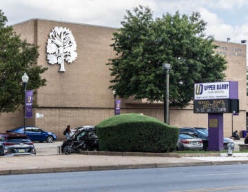 The exterior of Upper Darby High School is visible.