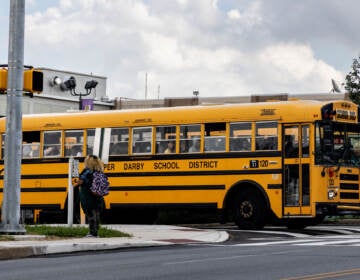 A school bus pulls out of a parking lot.