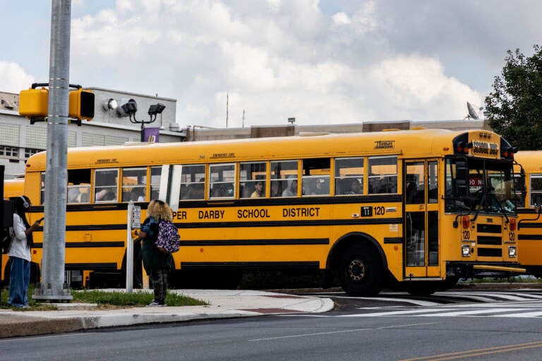 A school bus pulls out of a parking lot.