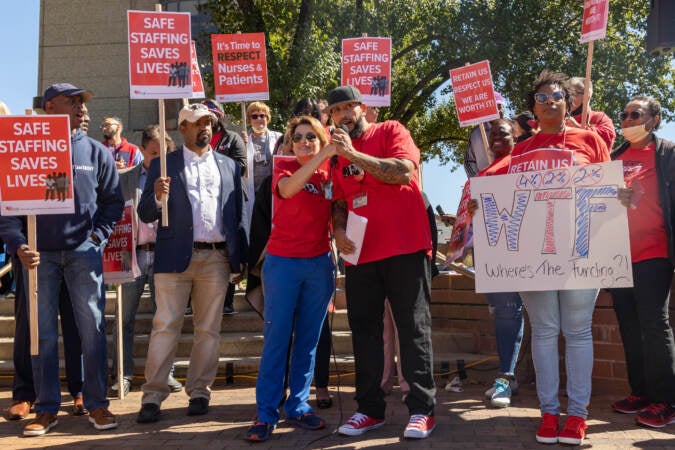 Temple University Hospital nurses president Mary Adamson (left) and pharmacy tech and union representative Carlos Aviles (right with mic) led a rally outside the hospital for a fair contract on Sept. 23, 2022. (Kimberly Paynter/WHYY)