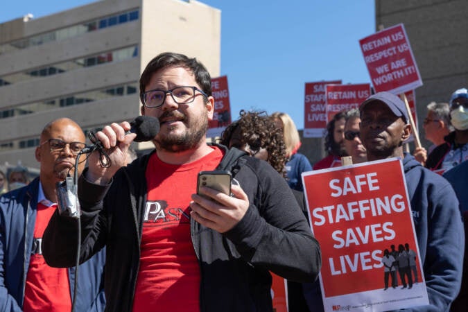 Timothy DeMuro, a medical respiratory unit ICU nurse, spoke about his experiences working during the COVID-19 pandemic at a rally of nurses fighting for a fair contract on Sept. 23, 2022. (Kimberly Paynter/WHYY)