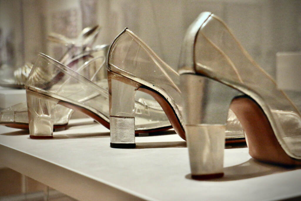 A row of high heels are visible up close.