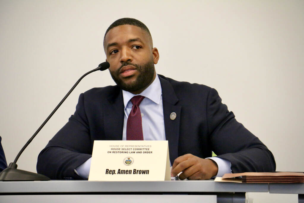 Amen Brown speaks into a microphone.