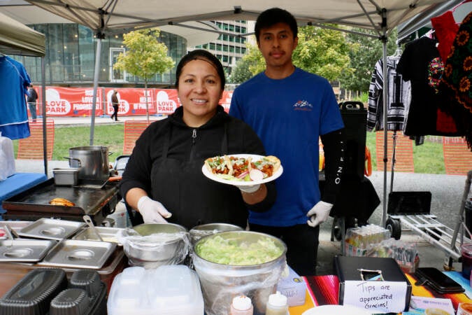 Felipa Ventura owner of Taqueria Morales offers soft tacos at her stand at the Latin America Thrives in Philadelphia event in Love Park. (Emma Lee/WHYY)