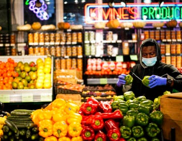 A grocer at the Reading Terminal Market in Philadelphia, Wednesday February 16, 2022  (AP Photo/Matt Rourke)