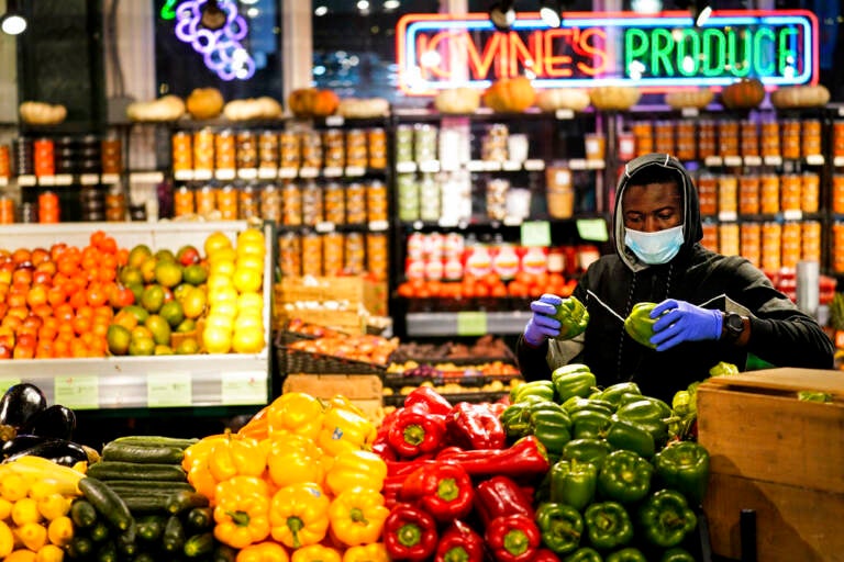 A grocer at the Reading Terminal Market in Philadelphia, Wednesday February 16, 2022  (AP Photo/Matt Rourke)