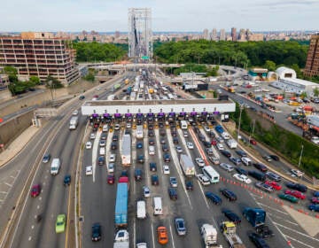 Traffic passes through the toll plaza at the George Washington Bridge in Fort Lee, New Jersey, on Friday, June 10, 2022. The busy bridge connecting New Jersey and New York City is moving to cashless tolls. Beginning in July, drivers paying cash tolls will have their license plates scanned and will be billed by mail. As part of the transformation, the tollbooths and islands will be demolished. (AP Photo/Ted Shaffrey)