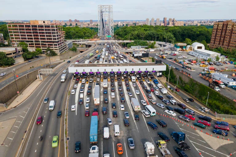 Traffic passes through the toll plaza at the George Washington Bridge in Fort Lee, New Jersey, on Friday, June 10, 2022. The busy bridge connecting New Jersey and New York City is moving to cashless tolls. Beginning in July, drivers paying cash tolls will have their license plates scanned and will be billed by mail. As part of the transformation, the tollbooths and islands will be demolished. (AP Photo/Ted Shaffrey)