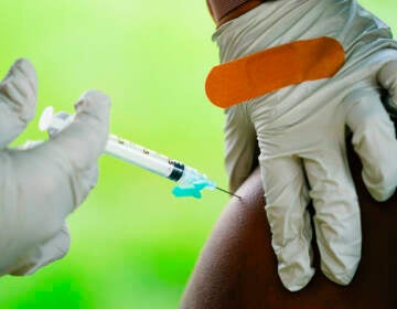 FILE - A health worker administers a dose of a Pfizer COVID-19 vaccine during a vaccination clinic in Reading, Pa., Sept. 14, 2021. (AP Photo/Matt Rourke, File)