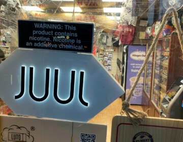File photo: A Juul electronic cigarette sign hangs in the front window of a bodega convenience store in New York City on June 25, 2022. (AP Photo/Ted Shaffrey, File)