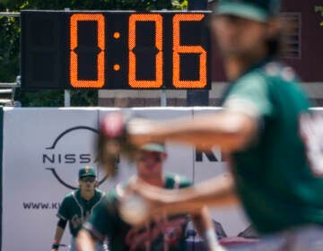 File photo: A pitch clock is deployed to restrict pitcher preparation times during a minor league baseball game between the Brooklyn Cyclones and Greensboro Grasshoppers, July 13, 2022, in the Coney Island neighborhood of the Brooklyn borough of New York. Major League Baseball is set to announce a pitch clock and limits on defensive shifts next season in an effort to shorten games and increase offense. The sport’s 11-man competition committee is set to adopt the rules changes Friday, Sept. 9. (AP Photo/John Minchillo, File)