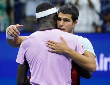 Carlos Alcaraz, of Spain (right) hugs Frances Tiafoe, of the United States, after winning their semifinal match of the U.S. Open tennis championships, Friday, Sept. 9, 2022, in New York. (AP Photo/John Minchillo)