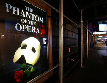 File photo: A poster advertising ''The Phantom of the Opera,'' is displayed on the shuttered Majestic Theatre in New York, March 12, 2020. (AP Photo/Kathy Willens, File)