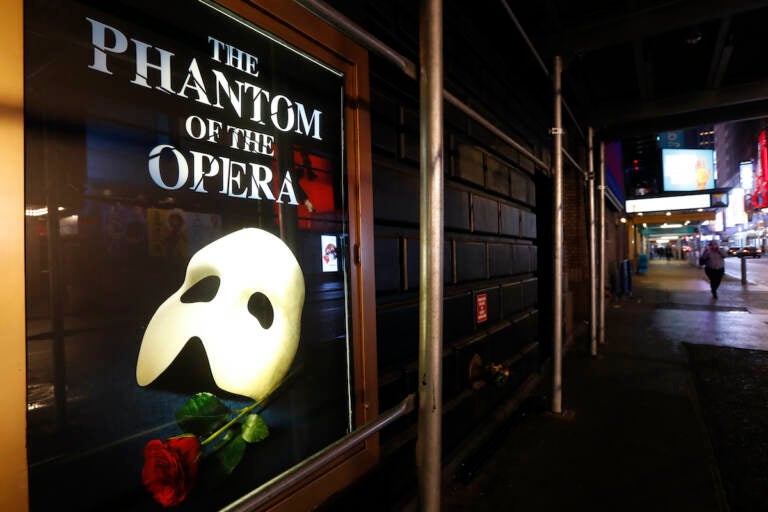 File photo: A poster advertising ''The Phantom of the Opera,'' is displayed on the shuttered Majestic Theatre in New York, March 12, 2020. (AP Photo/Kathy Willens, File)