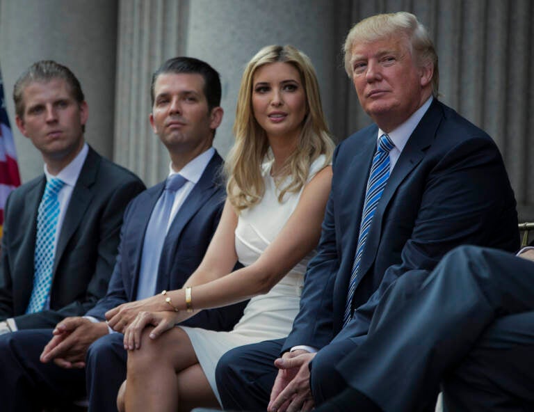 FILE - Donald Trump, right, sits with his children, from left, Eric Trump, Donald Trump Jr., and Ivanka Trump during a groundbreaking ceremony for the Trump International Hotel on July 23, 2014, in Washington. New York’s attorney general sued former President Donald Trump and his company on Wednesday, Sept. 21, 2022, alleging business fraud involving some of their most prized assets, including properties in Manhattan, Chicago and Washington, D.C. (AP Photo/Evan Vucci, File)