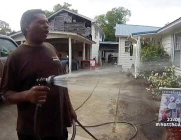 This image captured from bodycam video released by the Childersburg (Ala.) Police Department and provided by attorney Harry Daniels shows Michael Jennings, left, in custody in Childersburg, Ala., on May 22. Jennings was helping out a friend by watering flowers when officers showed up and placed him under arrest within moments. (Childersburg Police Department via AP)
