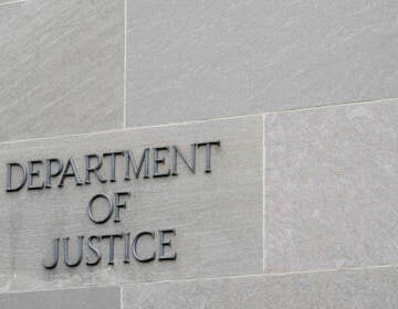 A sign marks the facade of the Department of Justice building in Washington on May 5, 2022. (Patrick Semansky/AP)