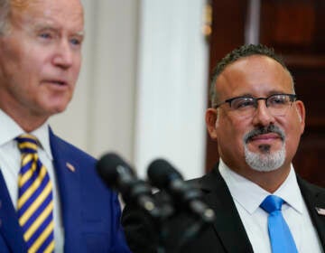 U.S. Education Secretary Miguel Cardona appeared alongside President Biden when he announced his student loan relief plan on Aug. 24. On Thursday, the administration quietly changed its guidance around which borrowers qualify for this relief. (Evan Vucci/AP)