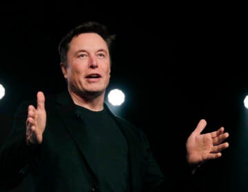 Elon Musk speaks against a black background
