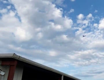 A small airplane circles over Tupelo, Miss., on Saturday. Police say the pilot threatened to crash the aircraft into a Walmart. (Rachel McWilliams/AP)