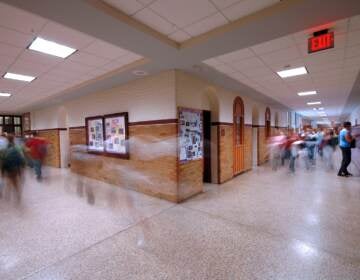 A school hallway with motion blur of students.