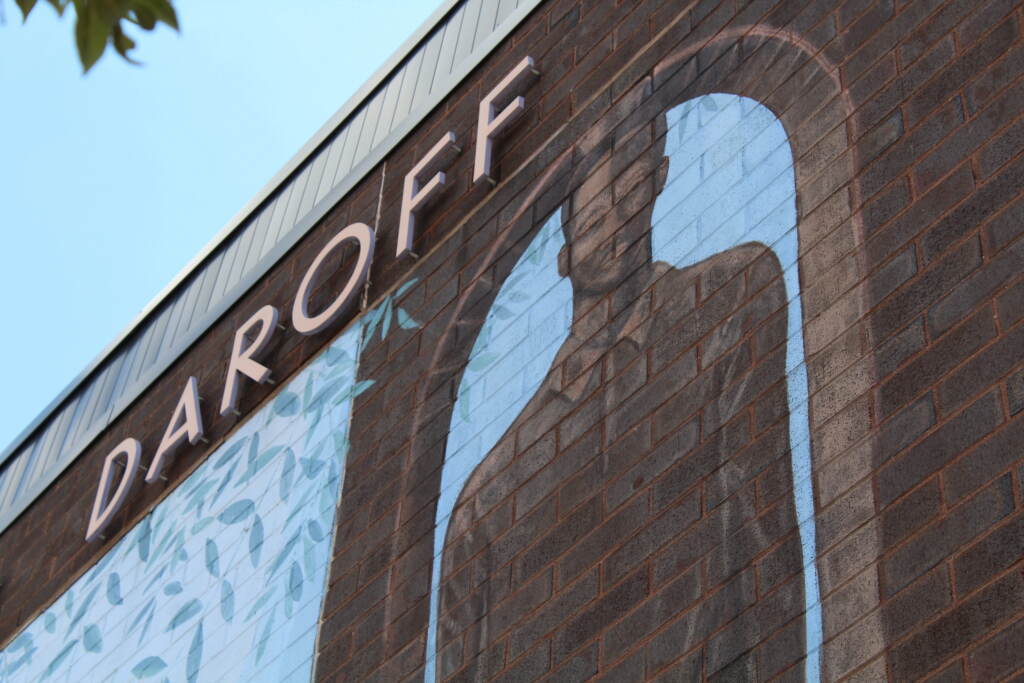 The word Daroff is written on a brick wall, where a silhouette of a student is also painted.