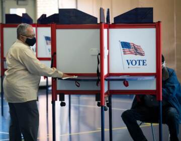 People vote at a polling place.