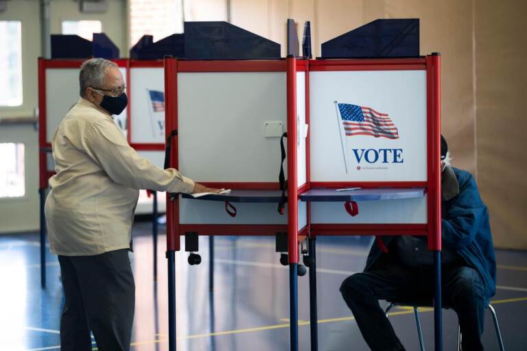 People vote at a polling place.