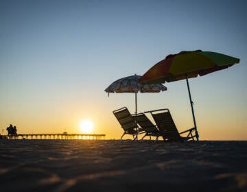 Beach chairs are seen as the sun rises in Ocean City, N.J., on Aug. 18. This is not the above-average hurricane season experts predicted — at least, not yet. (Al Drago/Bloomberg via Getty Images)