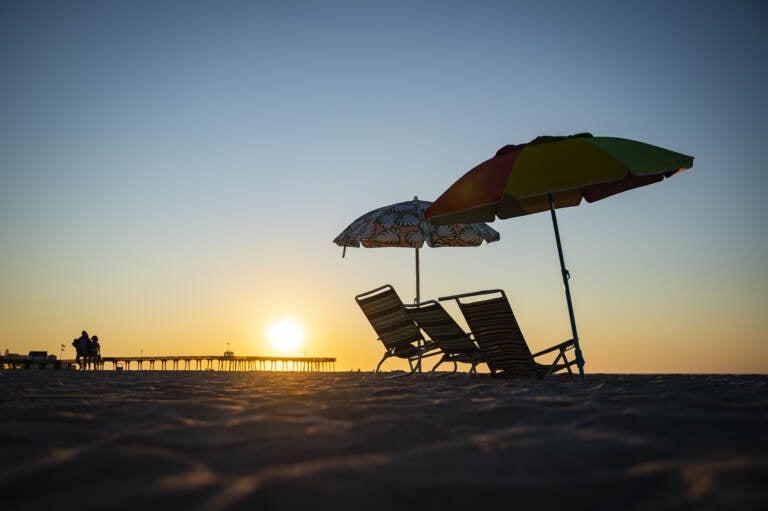 Beach chairs are seen as the sun rises in Ocean City, N.J., on Aug. 18. This is not the above-average hurricane season experts predicted — at least, not yet. (Al Drago/Bloomberg via Getty Images)