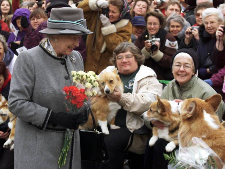 Queen Elizabeth II talks with members of the Manitoba Corgi Association during a visit to Winnipeg, Canada, in October 2002. (Adrian Wyld/AFP via Getty Images)