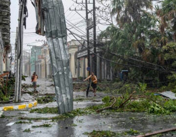 Fallen electricity lines, metal and tree branches litter a street after Hurricane Ian hit Pinar del Rio, Cuba, Tuesday, Sept. 27, 2022.  Ian made landfall at 4:30 a.m. EDT Tuesday in Cuba’s Pinar del Rio province, where officials set up shelters, evacuated people, rushed in emergency personnel and took steps to protect crops in the nation’s main tobacco-growing region. (AP Photo/Ramon Espinosa)