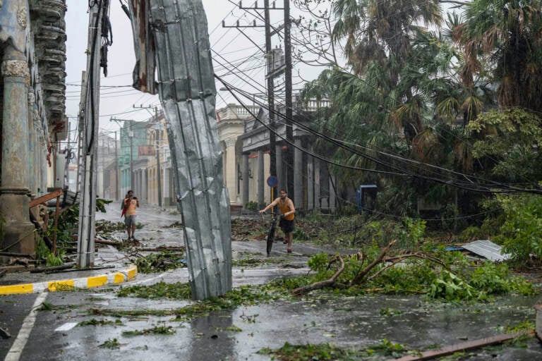 Fallen electricity lines, metal and tree branches litter a street after Hurricane Ian hit Pinar del Rio, Cuba, Tuesday, Sept. 27, 2022.  Ian made landfall at 4:30 a.m. EDT Tuesday in Cuba’s Pinar del Rio province, where officials set up shelters, evacuated people, rushed in emergency personnel and took steps to protect crops in the nation’s main tobacco-growing region. (AP Photo/Ramon Espinosa)
