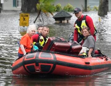 Residents are rescued from floodwaters in the aftermath of Hurricane Ian in Orlando