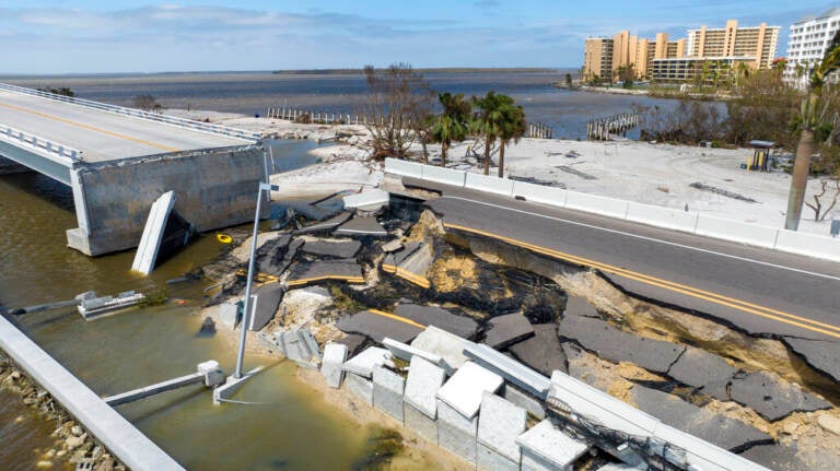 An aerial view of a causeway damaged by Hurricane Ian.