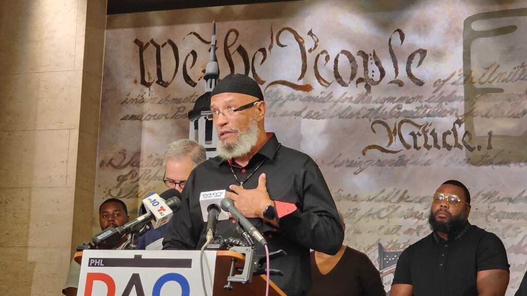 A man speaks at a podium.